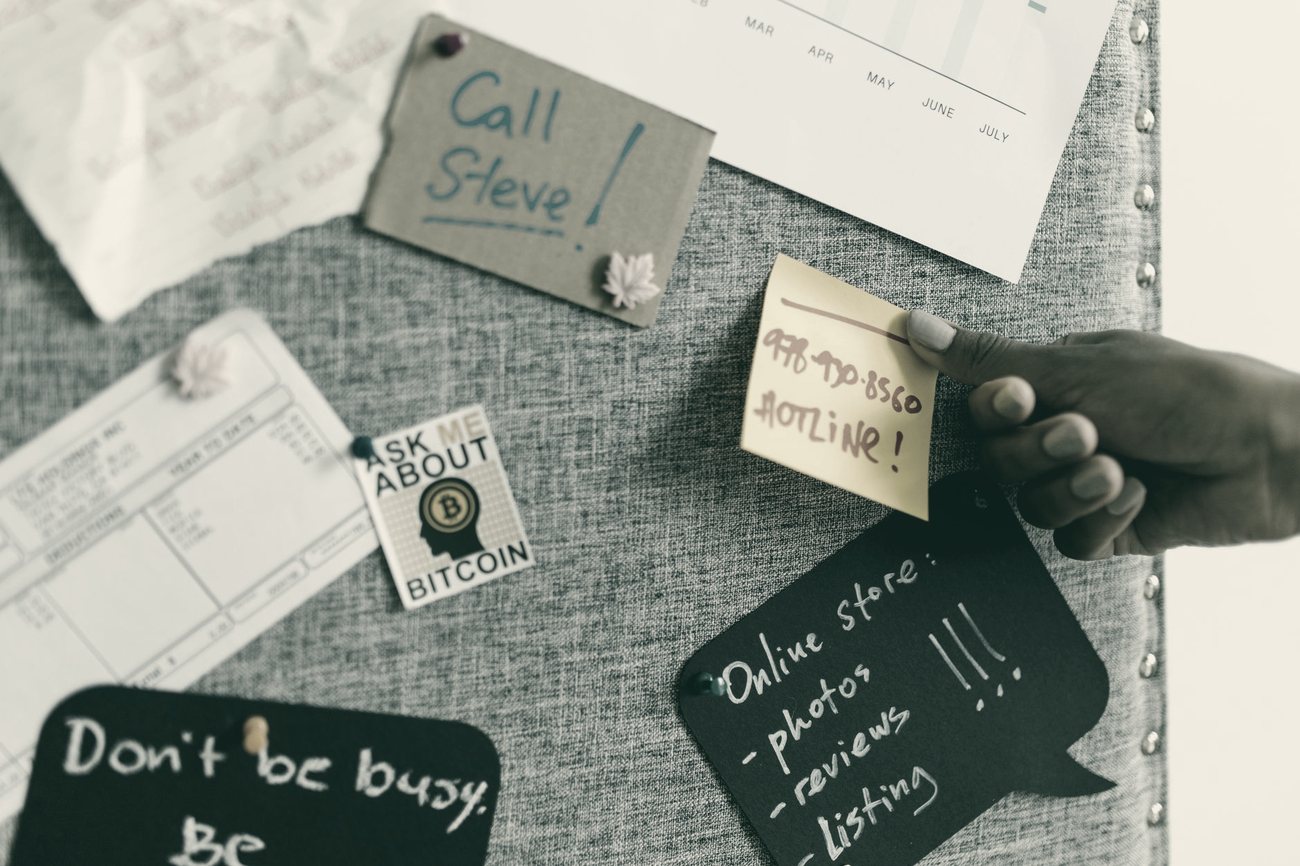 Notes, briefs and a hand at work — the raw material of an operation in motion.